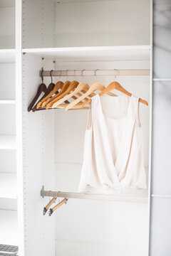 White shirts hanging neatly in closet, organized storage