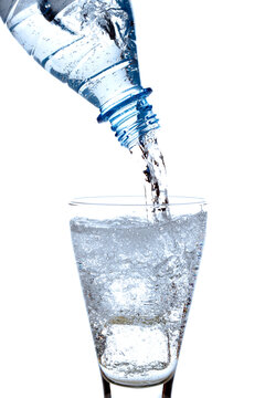 Mineral water being poured into glass, close-up