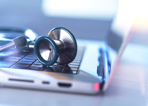 Stethoscope rests on a laptop keyboard for telemedicine concept