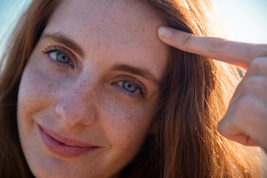Portrait of smiling young woman with freckles