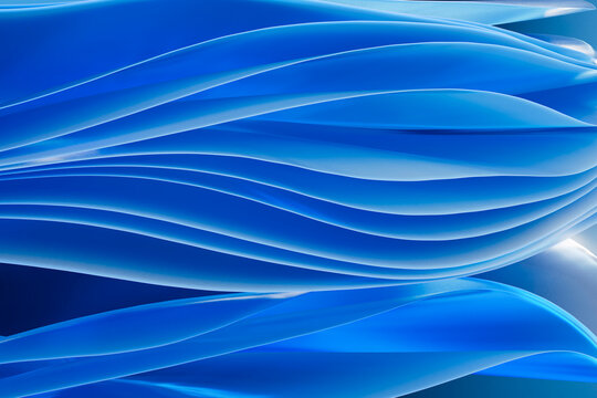 A modern 3D render displays a fluid layered blue geometric background