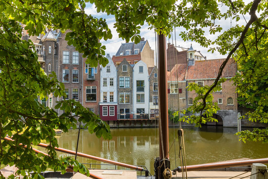 Mast of a sailing boat in front of historic warehouses in Delfshaven, Rotterdam, Netherlands