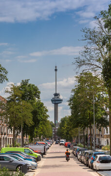 Euromast tower rises high at the end of a street in Rotterdam, Netherlands