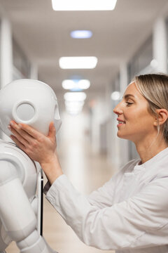 Scientist interacting with humanoid robot in medical research setting