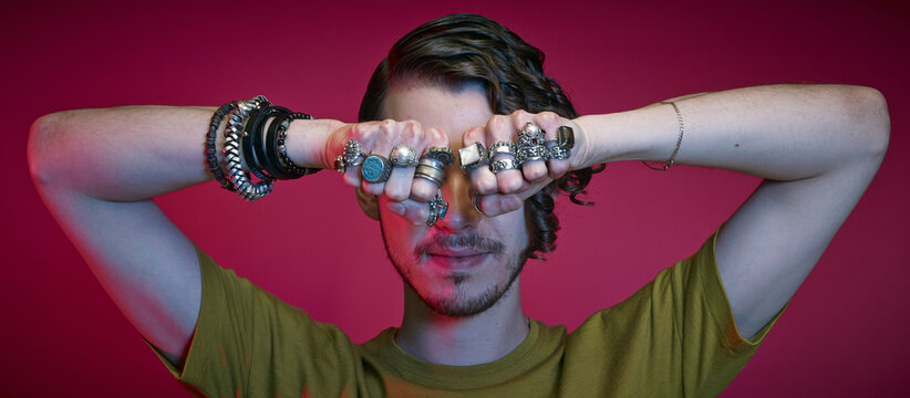 Young man presenting the rings at his fingers