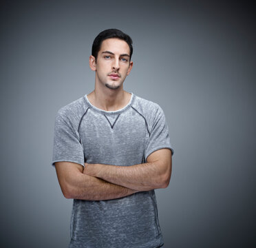 Portrait of young man with crossed arms