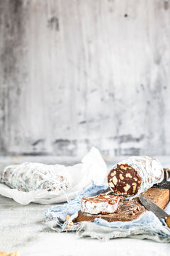 Sliced chocolate salami on wooden board