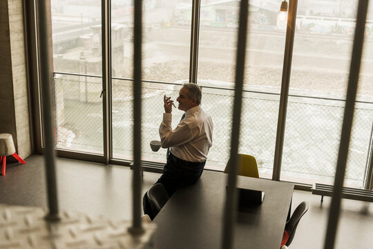 Senior manager in office sending voice mails