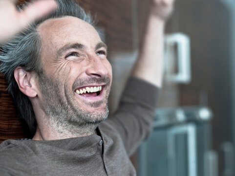 Germany, Hamburg, Man cheering and laughing, portrait
