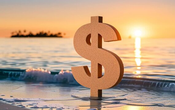 A textured dollar sign symbol stands upright on wet sand near the ocean shoreline during a warm golden sunset with gentle waves rolling in.
