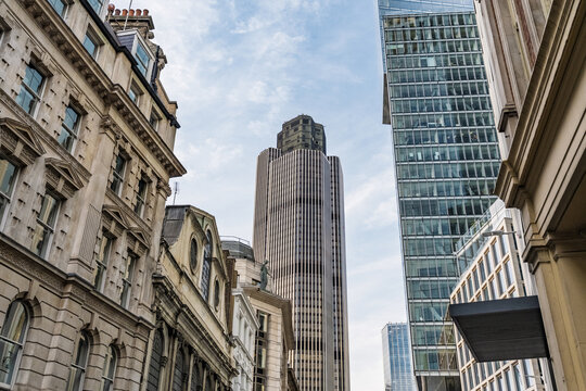 View of Tower 42 surrounded by historic stone buildings and modern glass skyscrapers in the City of London, England, United Kingdom.