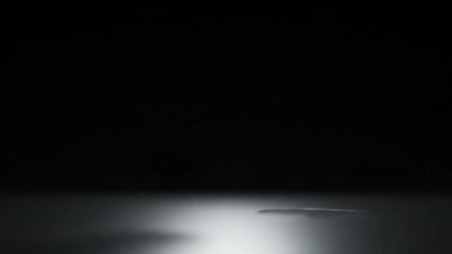 Cinematic spotlight moving across a dark textured floor creating dramatic shadows and intense lighting effects in this motion video footage