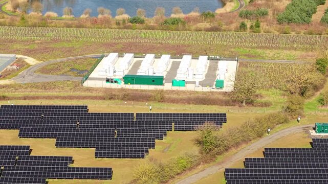 Forward drone flight over containerized lithium iron phosphate BESS battery storage facility