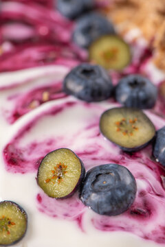 Macro Close-Up of Fresh Blueberries and Berry Compote Swirled in Creamy Yogurt