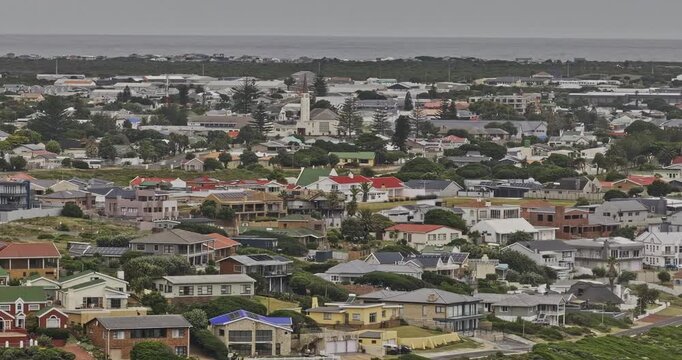 Gansbaai South Africa Aerial v5 long telephoto low flyover across shoreline residences and dense coastal townscape - Shot with Mavic 3 Pro Cine - Jan 7th 2024