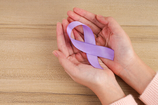 Top View of Purple Awareness Ribbon in Both Palms