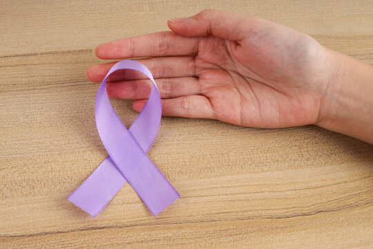Top View of Purple Awareness Ribbon Beside Open Palm