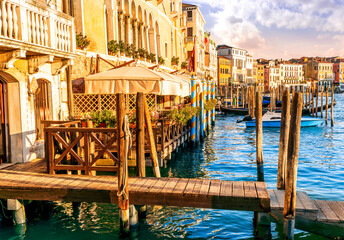 romantic view of a canal in Venice with boats and blue water and beautiful vintage buildings around the cityscape © Yaroslav