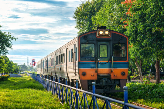 Vintage Diesel Train Moving Through Lush Green Landscape in Countryside of Thailand