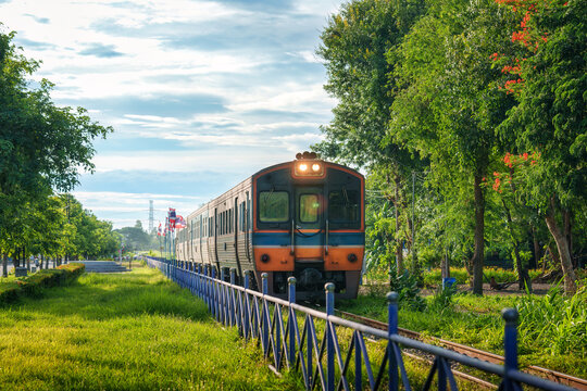 Vintage Diesel Train Moving Through Lush Green Landscape in Countryside of Thailand