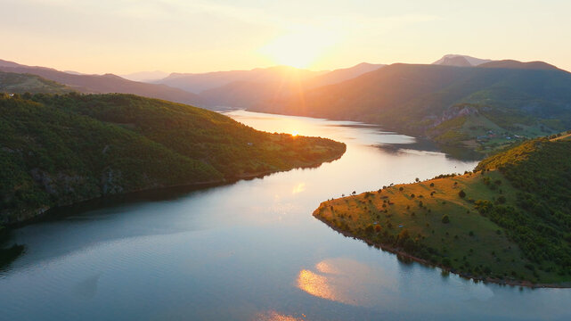 Kardzhali reservoir water reflection sunset aerial view Bulgaria Rhodope mountains winding lake travel background commercial stock photo horizontal