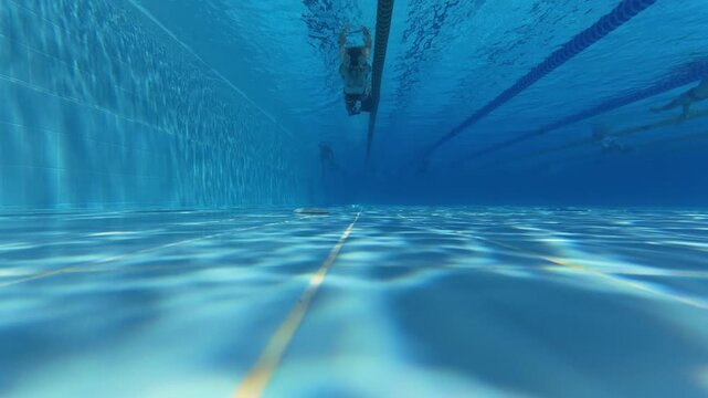Swimmer in Flippers Diving Underwater in Swimming Pool Lane