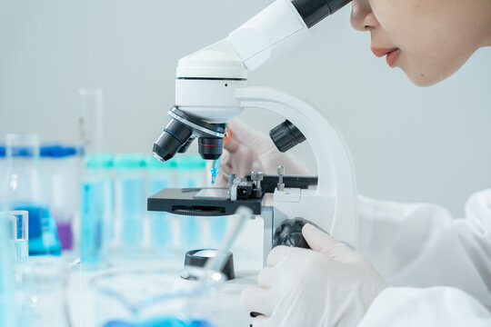 Scientist analyze biochemical samples in advanced scientific laboratory. Medical professional use microscope look microbiological developmental of viral. Biotechnology research in science lab.