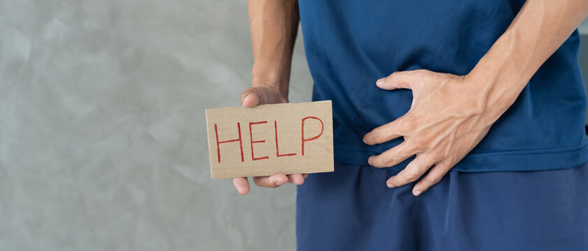 Man hold hand in front of private parts feeling discomfort from disease and inflammation. Venereal, testicular cancer. bladder problems, erectile dysfunction, premature ejaculation, prostate cancer