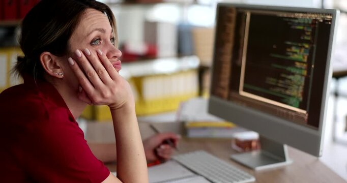 In a bright workspace, a developer sits deeply focused yet pensive, contemplating her next move as code fills the screen. The clock ticks, hinting at looming deadlines.