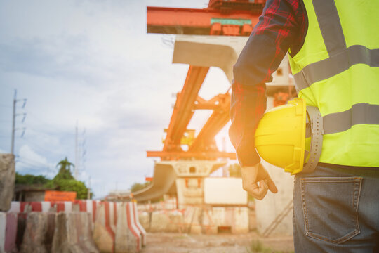 Asian workers are employed at a construction site for a new concrete bridge, a crucial infrastructure project for heavy urban transportation and bypass roads.