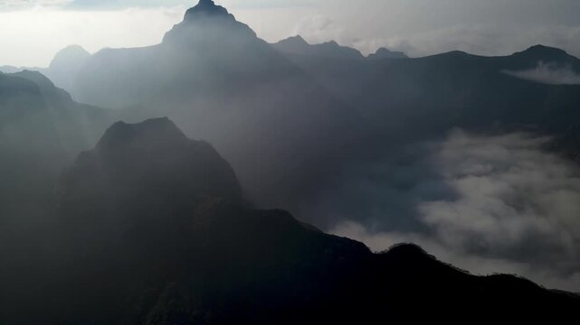 Aerial Scenery of Kelud Mountain Peak and Surrounding Volcanic Peaks Rising Above a Layer of Clouds in Morning Light. Dramatic Mountain Scenery in East Java, Indonesia.