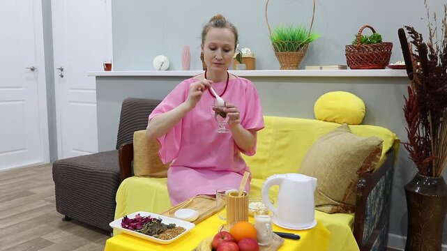 woman enjoying brewed herbal tea from ginkgo biloba leaves