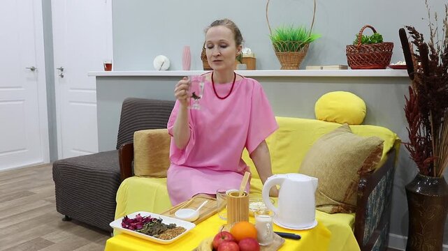 woman drinking brewed herbal tea from ginkgo biloba leaves