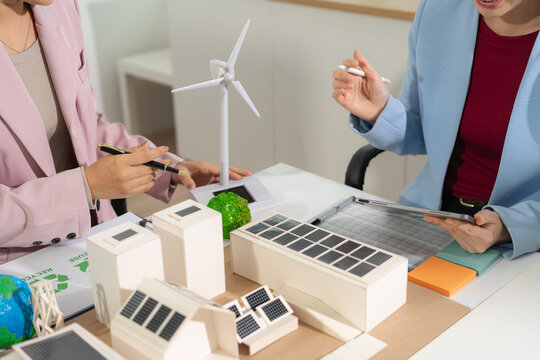 Business team, blueprint and site building job for architect, builder and engineer sketching a construction project, green energy and solar panel concept.