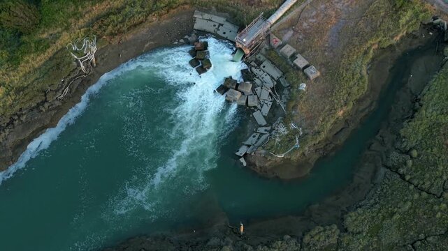 Top down aerial view of cooling water outfall pipe at Fawley oil refinery Southampton