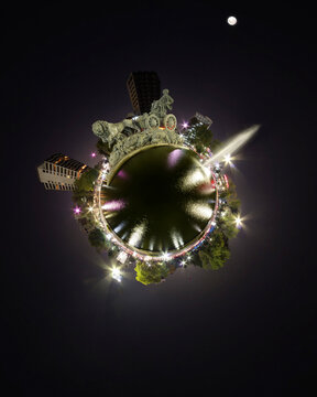 View of the Fuente de Cibeles fountain at night in a 360-degree panoramic perspective with surrounding city lights and the moon in the sky in Ciudad de Mexico, Ciudad de Mexico, Mexico.