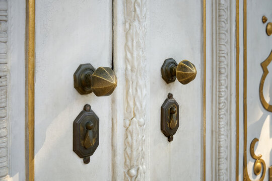 Close-up of the ornamental door bronze handles is located in the door.