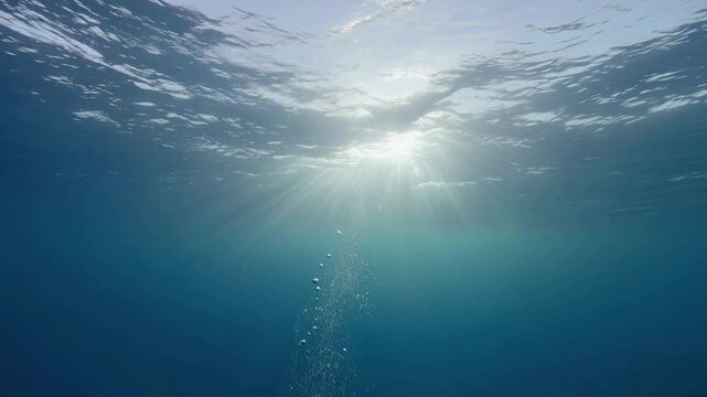 Underwater Ocean Surface View with Rising Bubbles and Cinematic God Ray Light Beams