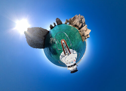 View of The Arch of Cabo San Lucas surrounded by turquoise water and a bright blue sky as seen from a boat in Cabo San Lucas, Baja California Sur, Mexico.