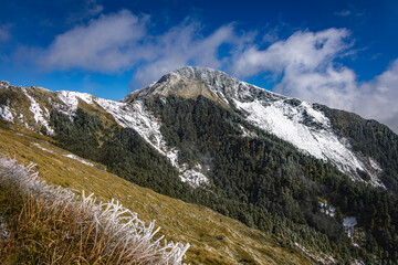 Snow covered Hehuanshan peak beneath drifting clouds in Taiwan © 柏佑 鄧