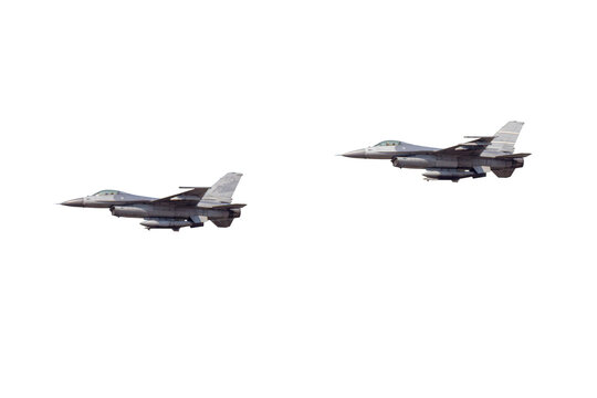 Two military fighter jets flying together in formation during flight mission.