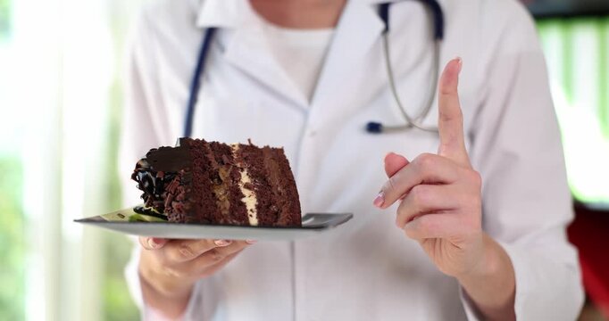 In a cheerful kitchen, a doctor presents a tempting slice of chocolate cake. With a playful gesture, they remind viewers about moderation in indulgence.