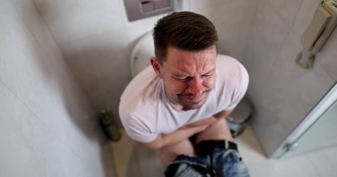 Caught in a hilarious situation, a man fidgets awkwardly while dealing with the urgency of bathroom needs. His expressions and reactions turn an ordinary moment into pure comedy.