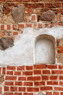 Weathered brick wall with stone masonry