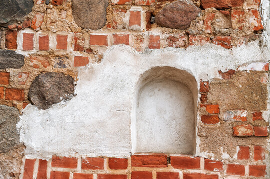 Weathered brick wall with stone masonry