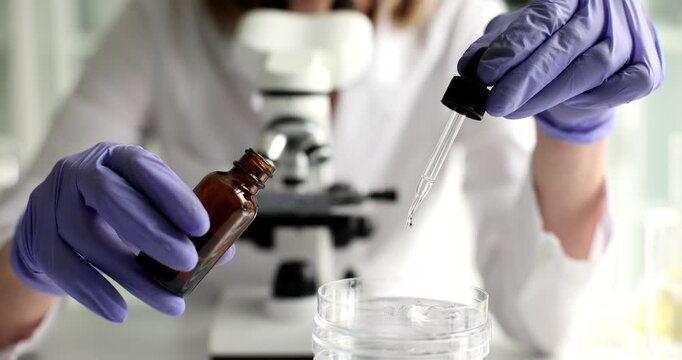 In a bright laboratory, a researcher in gloves skillfully handles a pipette, transferring liquids into a container. Each drop holds new discoveries and insights waiting to unfold.
