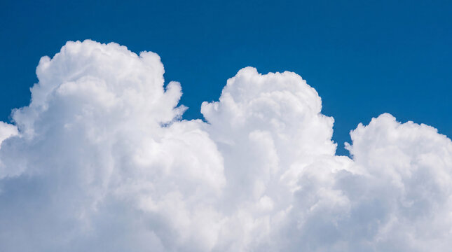 Vibrant blue sky with a distinct line of soft white cumulus clouds, symbolizing clarity and natural beauty.