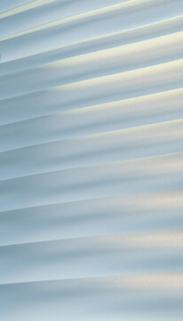Folded white paper forms layered abstract pattern with soft shadows