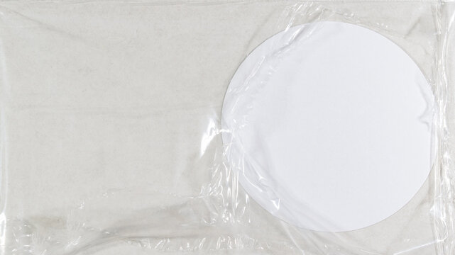 white round circular circle paper note behind damaged torn trasparent plastic wrap foil - Bright abstract frame sticky note background backdrop