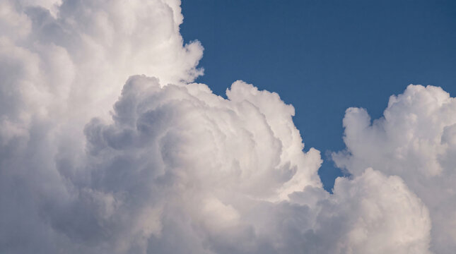 Majestic, dense white and gray clouds filling the expansive blue sky.